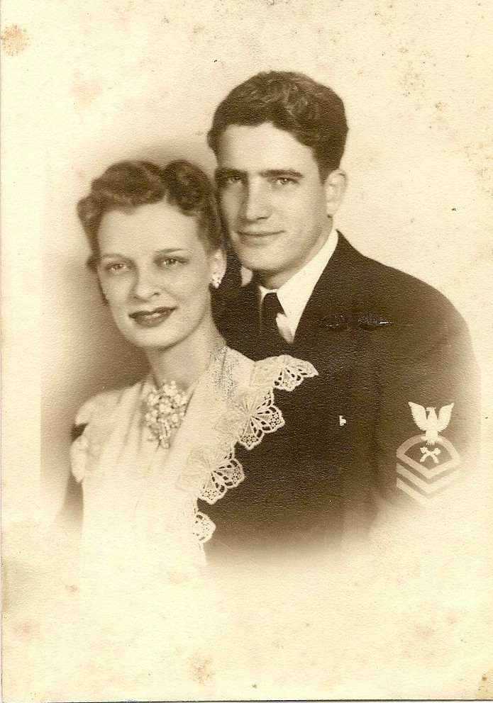Robert L. Miller and his bride in a 1942 studio portrait — he in Navy dress blues with a petty officer's rating badge on the sleeve, she in a pale gown with a lace collar and pearls.